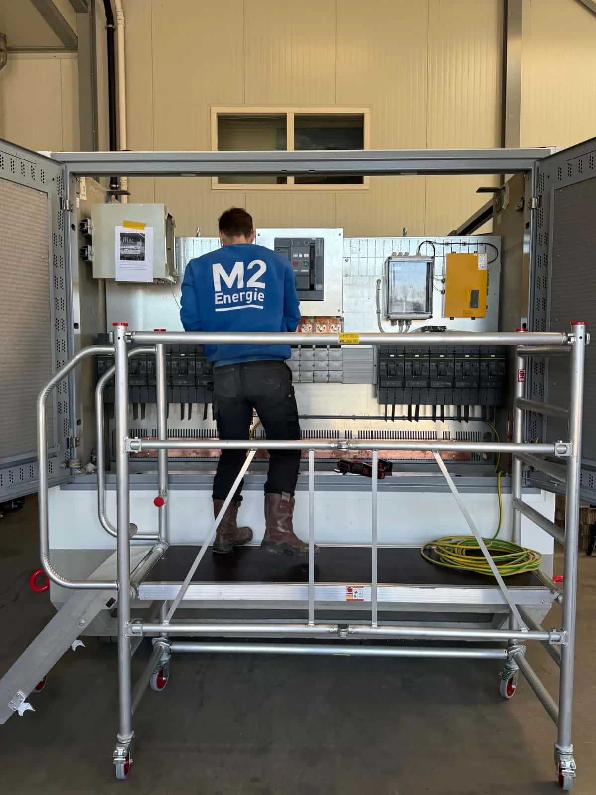 M2E-monteur bouwt een station op de assemblagelocatie in Emmen